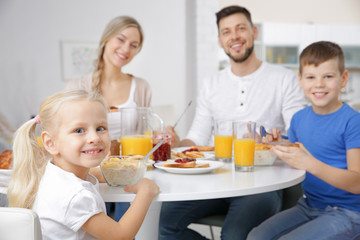 Wall Mural - Happy family having breakfast on kitchen