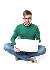 Young programmer using laptop on white background