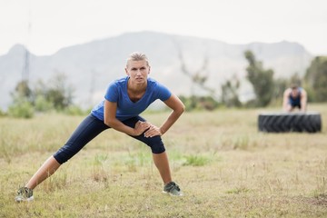 Wall Mural - Fit woman exercising in boot camp on a sunny day