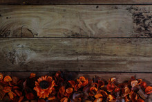 Orange Petals And Dried Flowers On Old Wooden Plates.