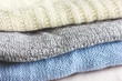 White, grey and light blue knitted sweaters 
