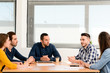 © W PRODUCTION - young casual and dynamic new business people team man and woman discussing on informal meeting with the company manager in office