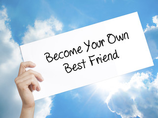  Become Your Own Best Friend Sign on white paper. Man Hand Holding Paper with text. Isolated on sky background