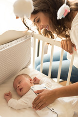 Wall Mural - mother putting baby to sleep