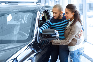 Beautiful African couple buying a car together