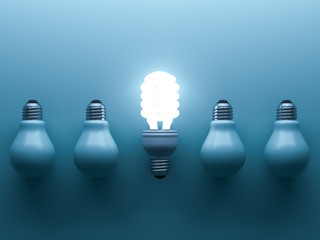 Poster - Energy saving light bulb up , one glowing fluorescent lightbulb standing out from unlit down incandescent bulbs on blue background , individuality and different creative idea concepts . 3D rendering.