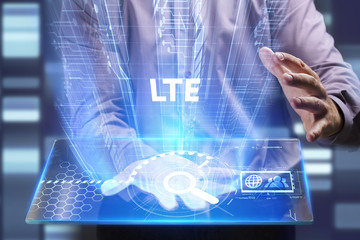 Business, Technology, Internet and network concept. Young businessman working on a virtual screen of the future and sees the inscription: LTE