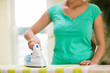 © Syda Productions - close up of woman with iron ironing towel at home