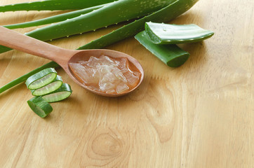 Wall Mural - sliced and leaf of fresh aloe vera with aloe vera gel product on wooden