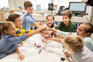 Wall Mural - happy children holding hands at robotics school