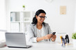 © Syda Productions - businesswoman with smartphone and laptop at office