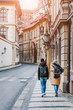 © EdNurg - Two young women walking in the Prague historic center together, back view