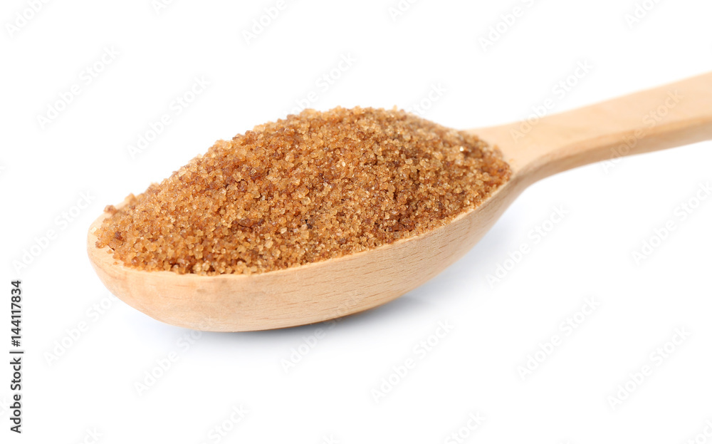 Heap of brown sugar in spoon, isolated on white