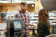 © Drobot Dean - Happy young man standing in supermarket shop