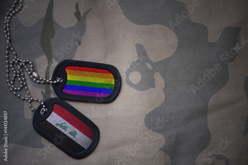 Stampe army blank, dog tag with flag of iraq and gay rainbow flag on the khaki texture background