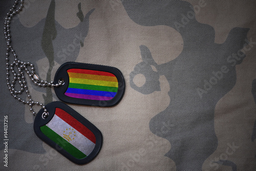 Fotografia army blank, dog tag with flag of tajikistan and gay rainbow flag on the khaki texture background