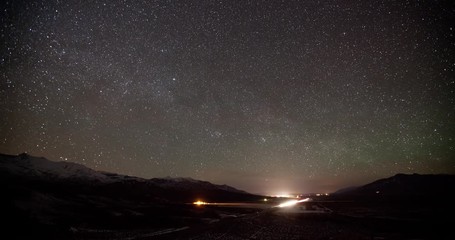 Wall Mural - Time lapse of the stars and Milky Way above a highway through the desert