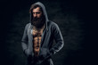 © Fxquadro - Bearded male with tattoo on a chest, dressed in a grey hoodie.