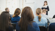 © KONSTANTIN SHISHKIN - Business woman at seminar - speaker female teaching at international conference, de-focused shot - horizontal