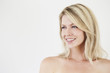 © sanneberg - Gorgeous smiling blond woman in white studio