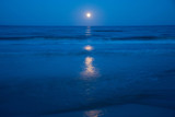 Fototapeta Tęcza - Sunset and the moon rising on the Mediterranean coast in southern Spain