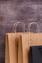 Wall Mural - Mockup of blank shopping bags. Brown and black craft packages. Concept for sales or discounts. Recycled paper. Wooden rustic board.