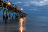 Fototapeta  - Fishing Pier at night with lights reflecting on water