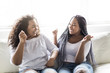© Louis-Paul Photo - affectionate friends afro american sitting on sofa