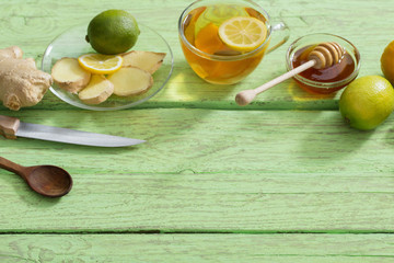 Wall Mural -  Ginger tea and ingredients on a  grunge wooden background