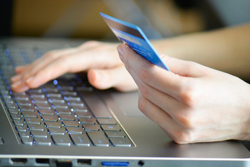 woman holding credit card on laptop for online shopping concept