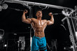 © bondarchik - Young handsome guy doing exercises in the gym