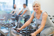 © pikselstock - Confident seniors on exercise bikes in spinning class at gym