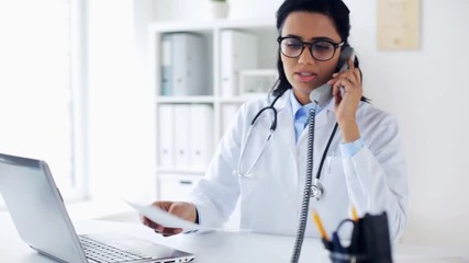 Poster - doctor with papers calling on phone at hospital