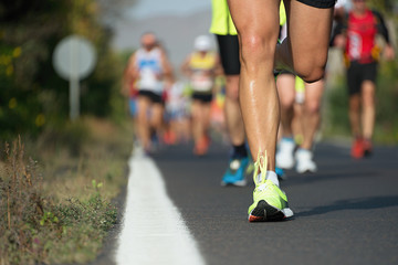 Wall Mural - Marathon running race, people feet on city road