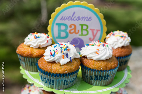 Cupcakes With White Cream Glaze With Powder And Sprinkles For Baby
