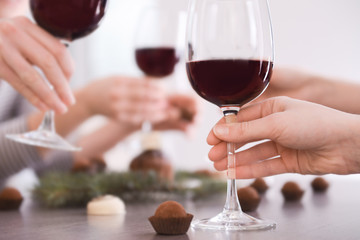 Sticker - Female hand holding glass of red wine closeup