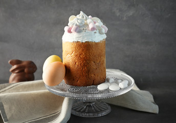 Wall Mural - Vintage cake stand with traditional Russian Easter bread and painted eggs on gray background