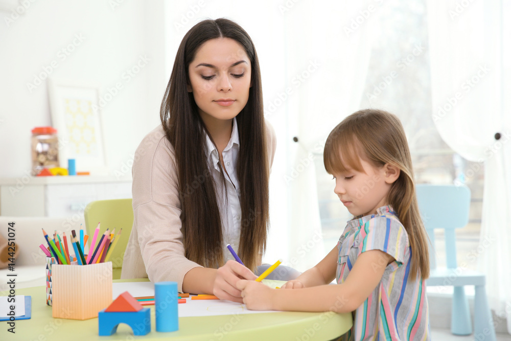 Young child psychologist working with little girl