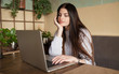 © lashkhidzetim - woman working with a laptop in a coffee shop or home terrace