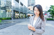 © leungchopan - Business woman use of mobile phone