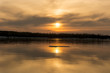 © Сергей Барабашев - Orange sunset on the river bank. Reflection of the sunset in the water. The ice floes on the water.