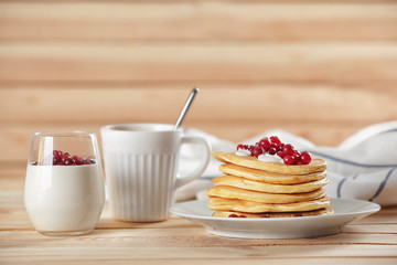 Sticker - Delicious pancakes with berries and yogurt on wooden table