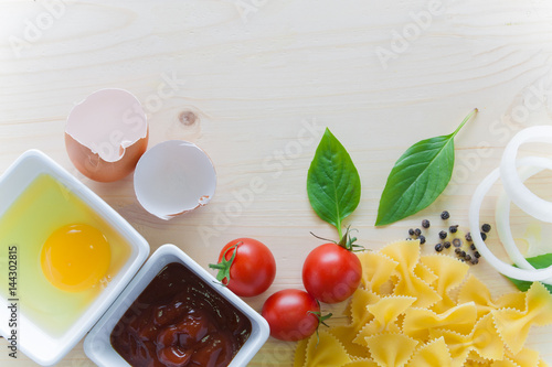 Stampe spaghetti with ingredients for cooking on wood background
