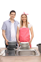 Wall Mural - Happy young couple with stacks of clean plates