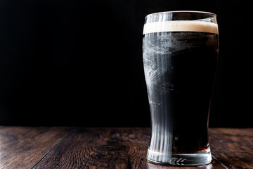 Poster - Dark Beer on wooden surface.