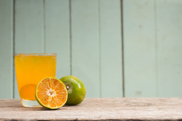 juice with slice of orange isolated on woods background.