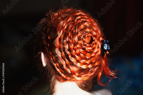A Woman With Red Curly Hair Braided In A Braid In A White Dress