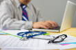 © Have a nice day  - Stethoscope with clipboard and Laptop on desk,Doctor working in hospital writing a prescription, Healthcare and medical concept,test results in background,vintage color,selective focus