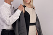 © dream@do - Social etiquette. Man giving a woman his jacket. Gentleman behavior. Couple in Love, Care concept.
