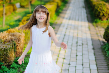 Portrait of happy little girl whith cherry tree flowers